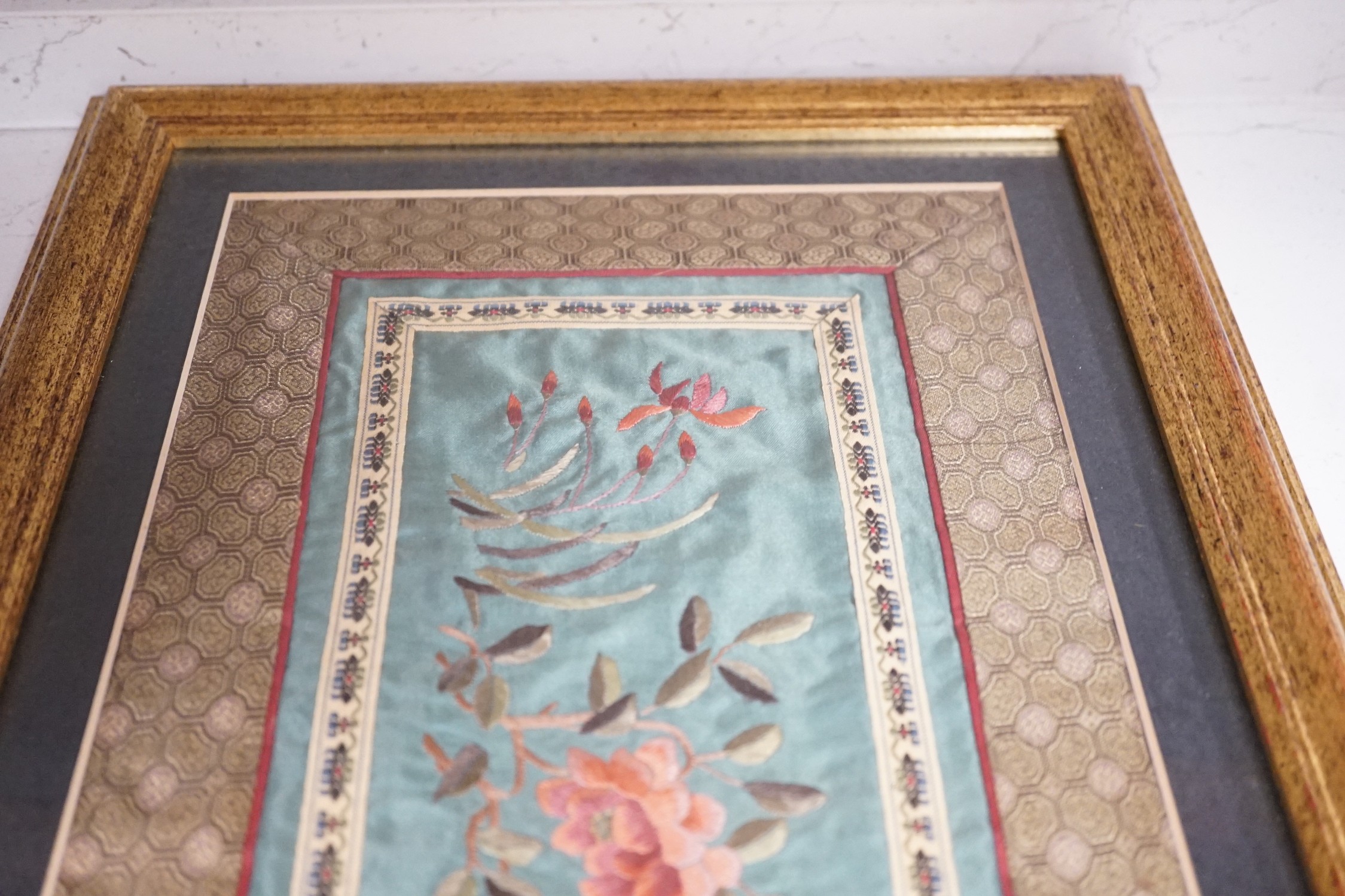 A pair of framed Chinese embroideries with bird and flower decoration, 34 x 14cm